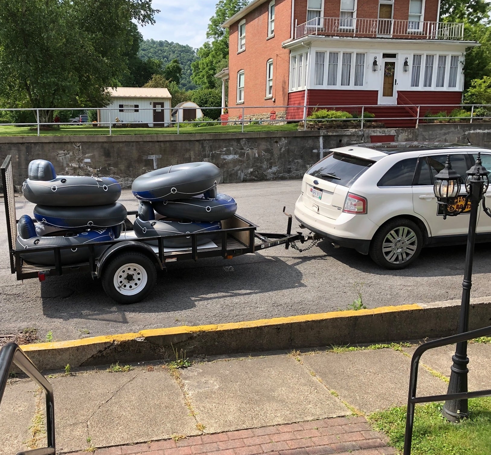 The boat shuttle by the lodge, with tubes in the trailer