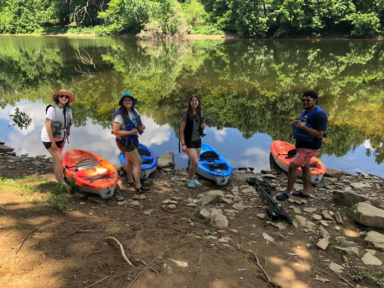 People in the river on canoes and kayaks