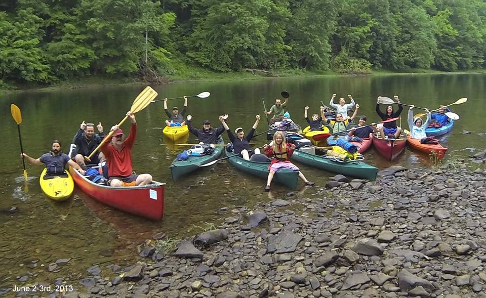 People in the river on canoes and kayaks